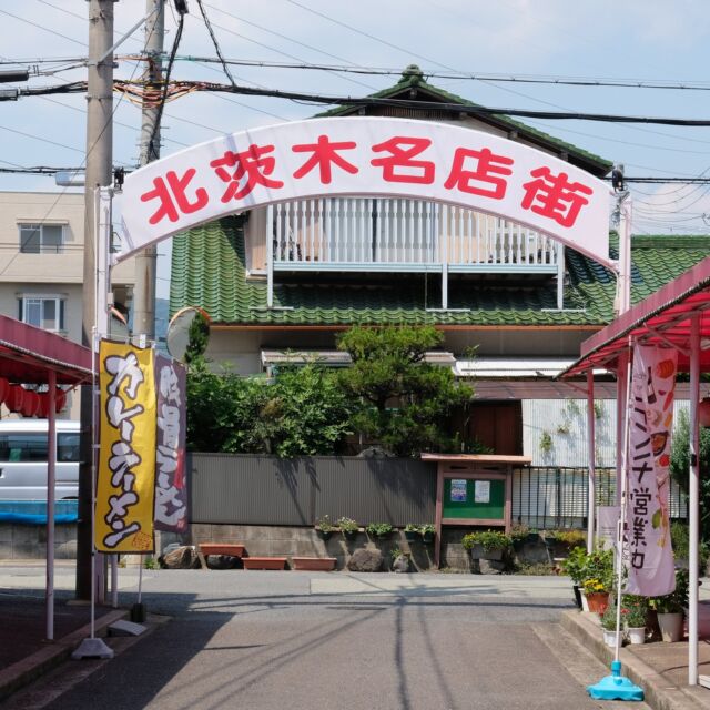 大阪府は茨木市、駅から離れた郊外の平和堂アル・プラザ茨木の北東側にあるのは北茨木名店街。

魚屋や八百屋、パン屋、中華料理屋、散髪店に自転車屋など、通りの長さは40mほどと小さいながらもフルセットの商店街です。

アーチはこれ以上ないぐらいシンプルで名前が目立つデザイン。

凝ったデザインのアーチを見るのも面白いですが、機能的にはこれで必要十分ですね。

Entrance arch of Kitaibaraki shopping street at Ibaraki, Osaka, Japan. 

2022
#アーチ看板 #アーチ #商店街 #商店街ゲート #街歩き #大阪府 #茨木市 #arch #street #japan_photo #japan #Osaka #Ibaraki #北茨木名店街 #シンプル